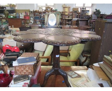 A Georgian style oak supper table, having dish and moulded top over a tripod base