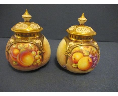 A pair of Royal Worcester covered quarter lobed pot pourri vases, decorated half round with hand painted fruit by Banks, heig