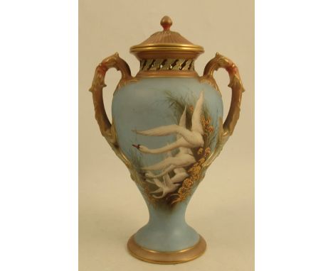 A Royal Worcester covered vase, decorated with swans to a powder blue ground, attributed to C H C Baldwyn, with pierced neck 