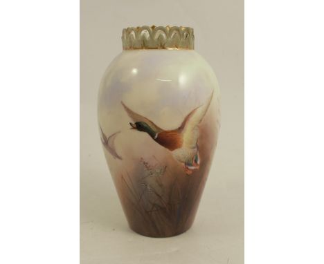 A Royal Worcester vase, decorated with mallards in flight by James Stinton, having pierced green fret rim, shape G682, height