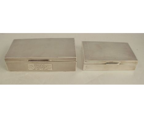 Two silver cigarette boxes, of rectangular form with engine turned decoration, one with presentation inscription, Birmingham 