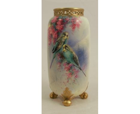 A Royal Worcester spill vase, decorated with two budgerigars and flowers, raised on four scrolling feet, with pierced neck, s
