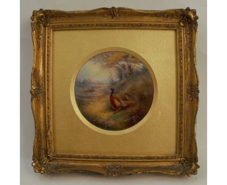 A Royal Worcester circular porcelain plaque, decorated with a cock and hen pheasant in landscape by Jas Stinton, dated 1930, 