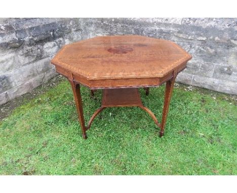 An Edwardian mahogany&nbsp; octagonal shaped centre table, with cross banded decoration, raised on four tapering legs, united