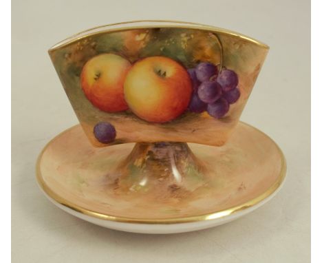 A Royal Worcester porcelain cigarette holder, raised on a small dish, decorated with hand painted fruit by Shuck, height appr