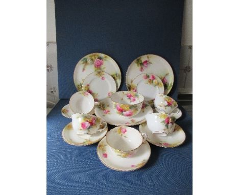 A Royal Worcester part service, decorated with roses by Spilsbury, comprising 5 cups, 4 saucers, a sugar bowl, 2 side plates,