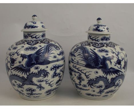 A pair of covered Chinese vases, decorated all around with dragons, Chinese seal mark to the base, height 10.5insCondition Re