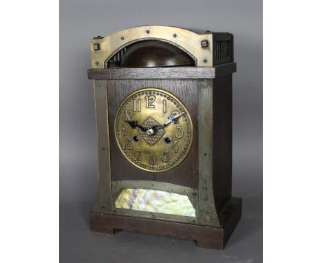 An early 20th Century oak and brass mantel clock of Arts & Crafts design possibly retailed by Liberty, the movement probably 