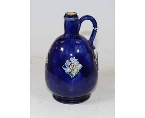 A Royal Doulton stoneware flagon, on a mottled blue ground with raised floral decoration and loop handle, having printed lion
