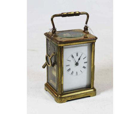 An early 20th century lacquered brass cased carriage clock, having enamelled dial with Roman numerals, with visible platform 