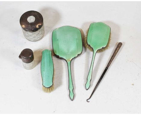 A George V silver and green guilloche enamelled part dressing table set to include hand mirror and two brushes, together with