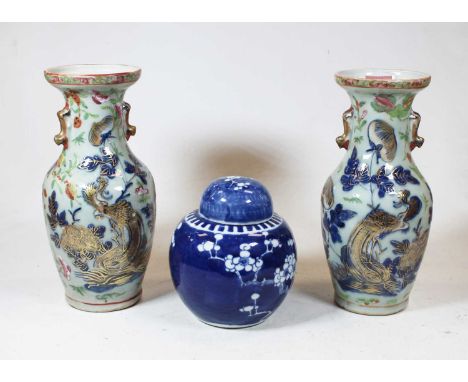 A pair of stoneware vases, each of baluster form, enamel decorated with various birds, butterflies and flowers, h.25cm; toget