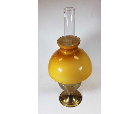 An early 20th century brass pedestal oil lamp, having opalescent glass shade