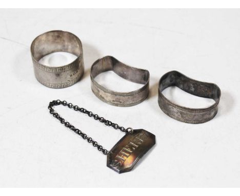 A pair of Edwardian silver napkin rings, together with one other silver napkin ring, silver decanter collar for sherry (4)