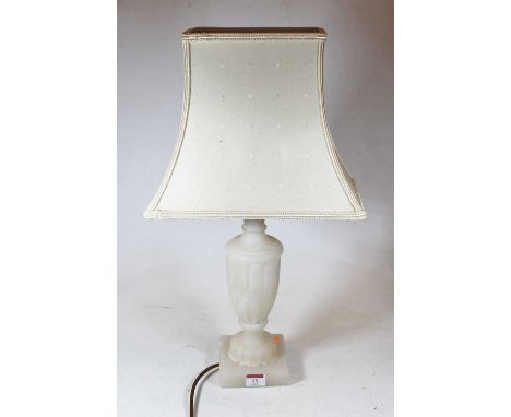 A carved alabaster table lamp, of fluted urn shape, on a square plinth, with shade, h.53cm 