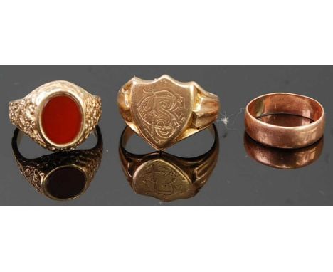 A 9ct gold textured band and agate set signet ring, size L; together with a 9ct gold shield shape gent's signet ring; and a s