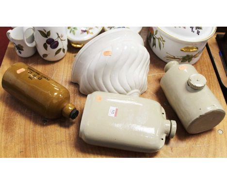 A collection of three stoneware foot-warmers; together with a continental ceramic wall pocket (4)