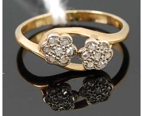 An 18ct gold and small rose cut diamond set flower head crossover ring, 1.7g, size I