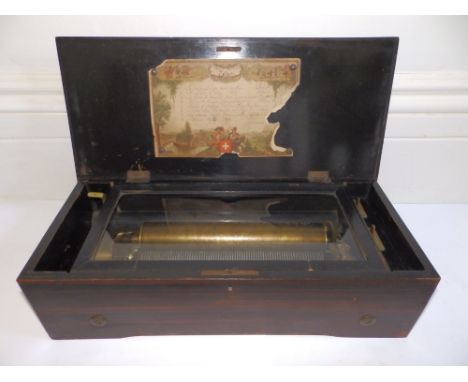 A late 19thC Swiss lever wind cylinder musical box, the 11” cylinder playing eight airs , the inlaid  rosewood case decorated