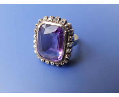 An amethyst & diamond rectangular cluster rin on yellow metal shank.