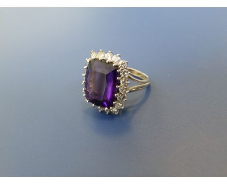 A modern amethyst & diamond cluster ring of cushion shape, set in white metal.