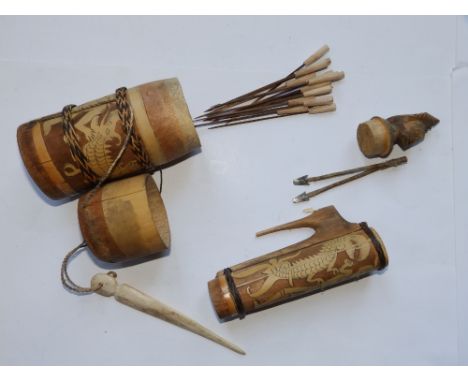 Two tribal poison arrow containers and one other.