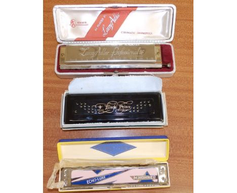 A boxed Hohner 'Larry Adler Professional' harmonica, an 'Echo-Luxe' harmonica and one other. (3)