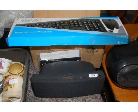 A wireless keyboard and mouse and a "Celestion" loud speaker.
