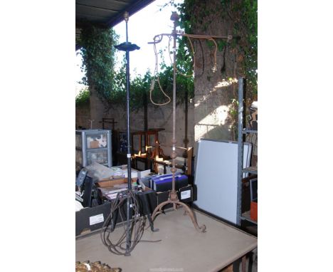 Two wrought iron standard lamp bases.