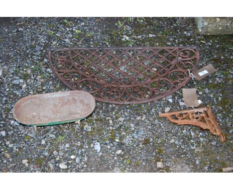 A small quantity of cast iron items including demi lune grate, bath and brackets.