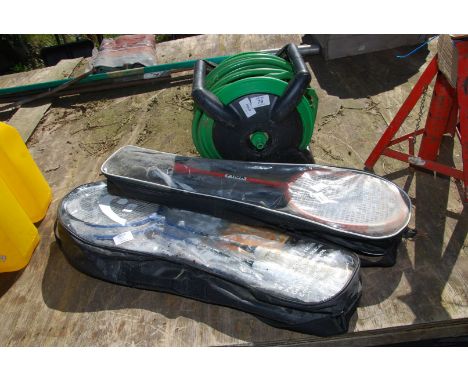 A hose on a reel and two Badminton sets.