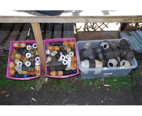 Three boxes of plastic pipe fittings.