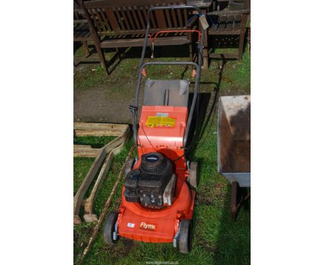 A Flymo easy start petrol mower with Briggs and Stratton engine, [engine turns and has good compression].