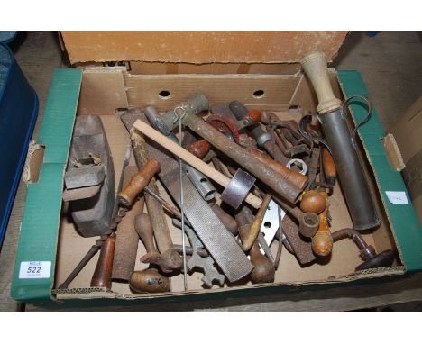 A box of old tools, hammers, files, wood plane, hand drill, etc.