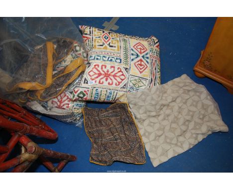 A bag of cushions and cushion covers.