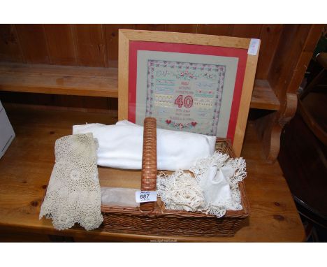 A wicker basket of lace doilies,etc and a Ruby Wedding tapestry.