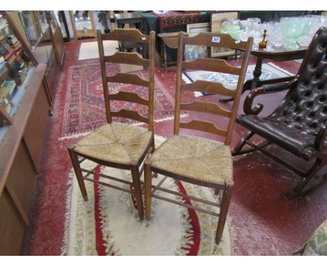 Pair of oak ladder-back chairs