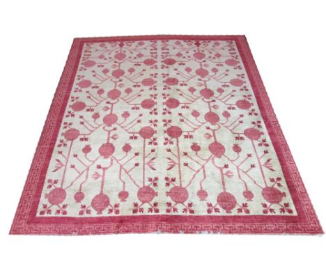 KHOTAN CARPET, 290cm x 249cm, all over geometric design in red on an ivory field within a corresponding border. 