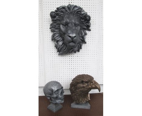 WALL PLAQUE, in the form of a lion's head 38cm H, skull table ornament 21cm H and an eagle's head 27cm H. (3)
