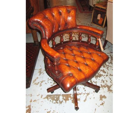 REVOLVING DESK CHAIR, tan hide leather upholstered with deep button back and seat revolving and reclining on an adjustable ba