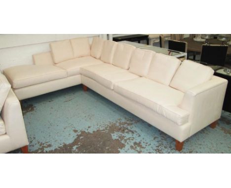 CORNER SOFA, in cream, with eight back cushions on square supports, 324cm x 214cm. 