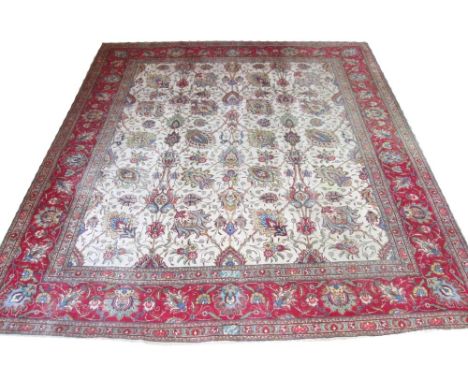 TABRIZ CARPET, 337cm x 300cm, allover design of palmettes and vines on an ivory field within a corresponding rouge border.