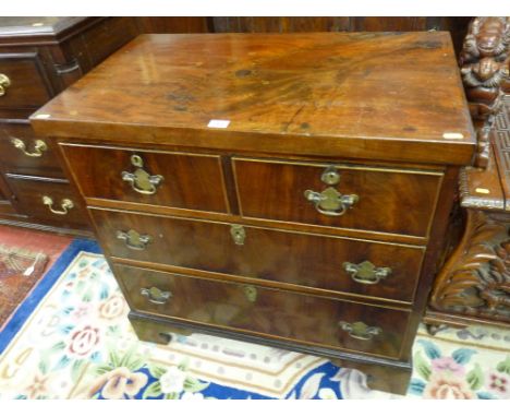 A SMALL MAHOGANY CHEST of two short over two long drawers on ogee bracket corner feet, the cock beaded drawers with shaped ba