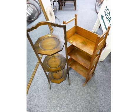 A NEAT OAK THREE SHELF OPEN BOOKCASE with decorated side panels and an Edwardian three tier folding cakestand