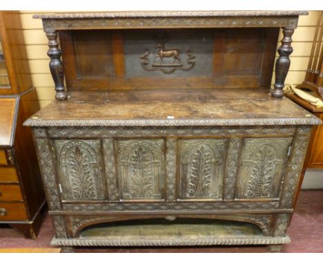 A GEORGE III AND LATER JACOBEAN STYLE SIDEBOARD, pollard and mixed period oak having a carved shelf top on baluster supports,