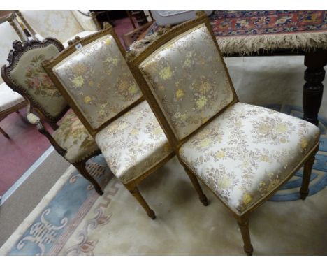 A PAIR OF FRENCH STYLE GILT BEDROOM CHAIRS in a satin floral upholstery and a French walnut armchair with carved top rail and