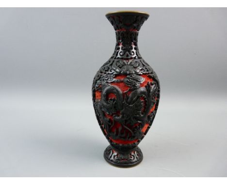 A CHINESE CINNABAR LACQUER BALUSTER VASE, 20th Century, red and black high relief carving with opposing panels of dragons cha