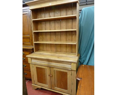 A VICTORIAN PINE DRESSER/BOOKCASE CONVERSION with inverted shaped cornice over four open shelves, single lower frieze drawer 