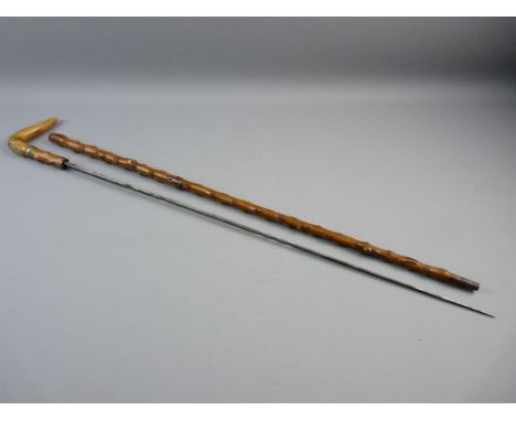 A BRIARWOOD ENCASED PULL-OUT SWORD STICK having a bone handle with small inlaid silver crest and a silver band, clean blade w