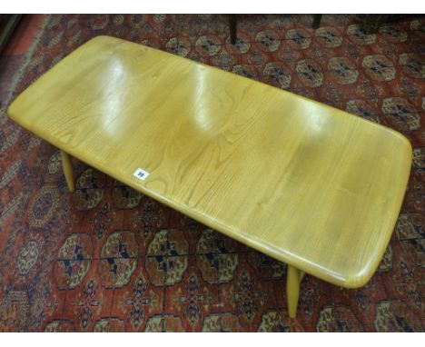 AN ERCOL LIGHT ELM COFFEE TABLE, rectangular form with under tier magazine rack, 36 cms high, 104 cms wide, 46 cms deep